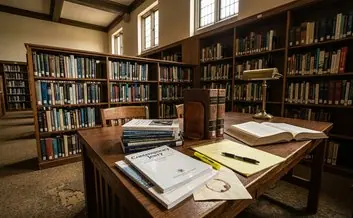Academic journals stacked on library desk